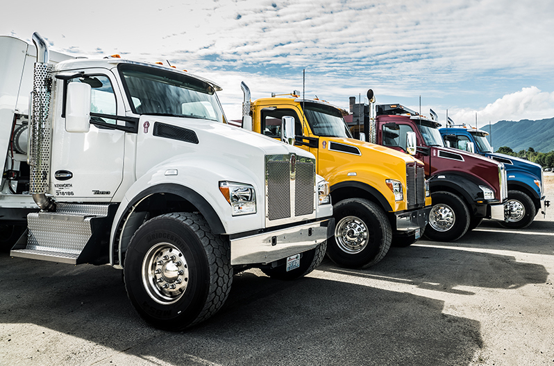 A row of Kenworth T880 trucks parked