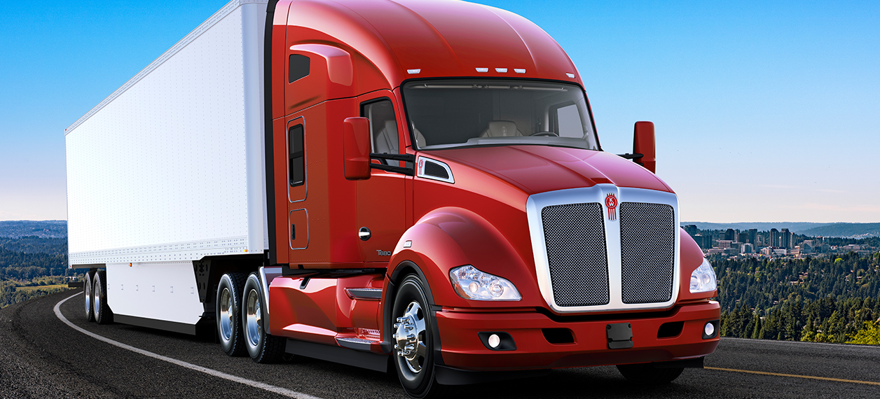 Kenworth T680 driving on the highway with city in the background