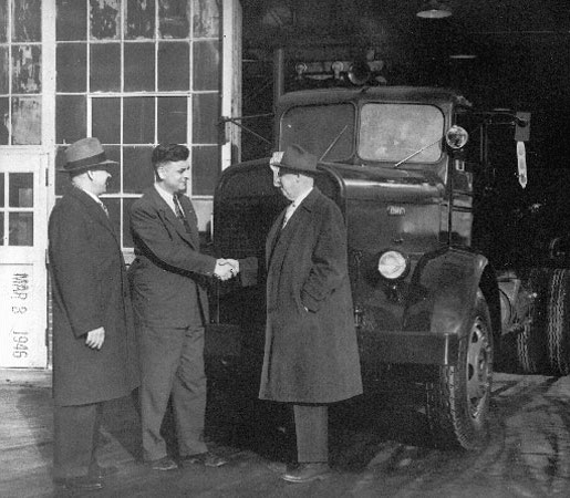 Old image of men shaking hands