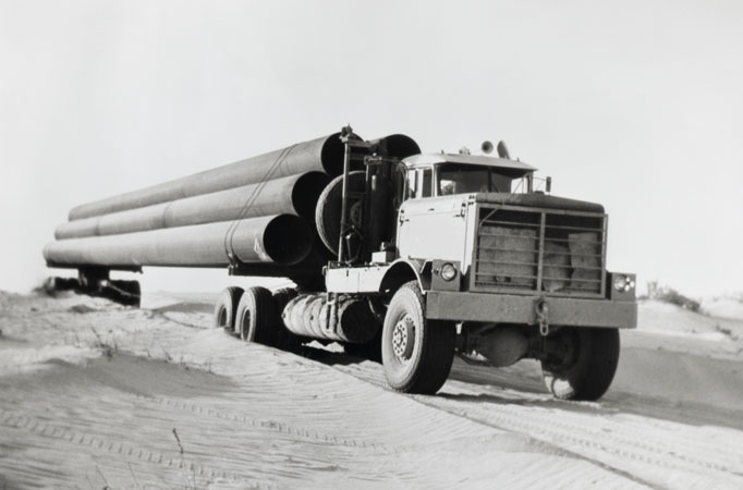 Kenworth truck transporting pipes in the oil fields