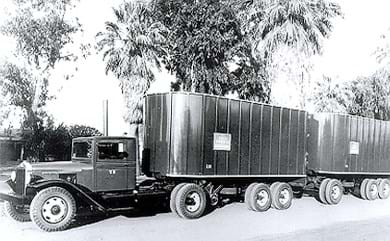 Old photo of Kenworth truck transporting cargo