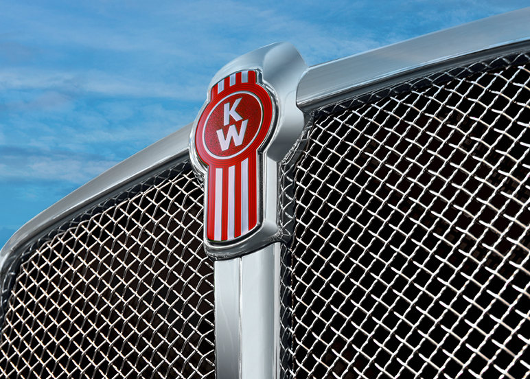 Closeup view of Kenworth truck grille with blue sky in the background